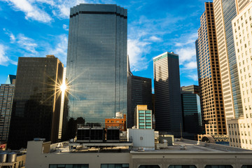 Downtown Dallas. Looking at rooftops and the light flaring between two buildings. - 86487600
