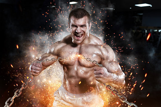 Athlete muscular bodybuilder man emoticon tear chain in the gym