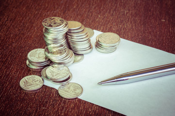Pen and coins with filter effect retro vintage style