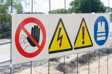 Warning signs on fence at construction site