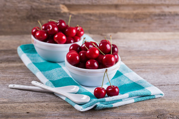 Cherries in a bowl on the table. The view from the top. Crop, orchard, berries. Healthy nutrition....