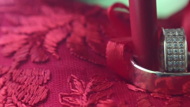 Wedding rings on red pillow