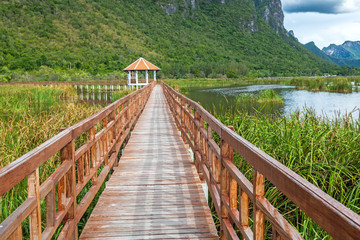 Fototapeta na wymiar Beautiful of wooden bridge and lake in Sam Roi Yot National Park