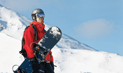 Male snowboarder with a board with copy space
