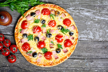 pizza with bacon, olives and tomato