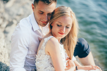 a young couple sitting on the beach