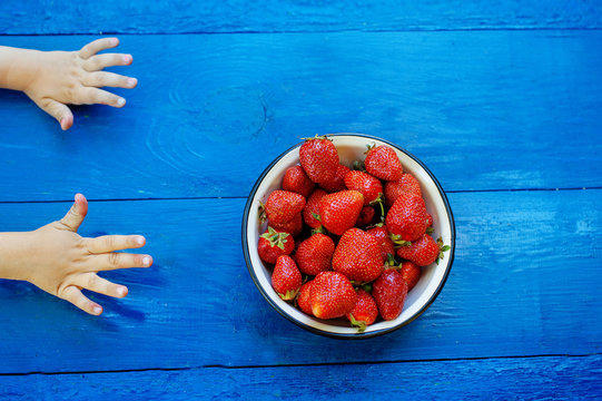 Little Hands Reach For The Strawberry