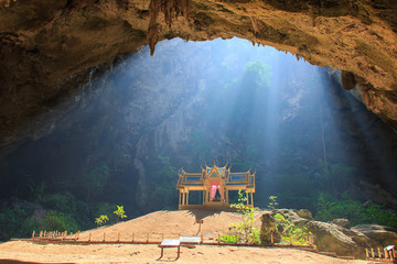 Obraz premium Morning sunbeam on golden buddhist pavilion in wild cave, Sam Roi Yot, Thailand