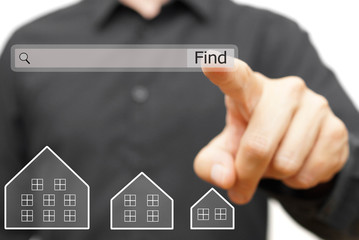 businessman is using internet search bar to  find real estate