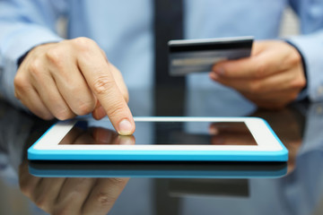 businessman is buying goods  on tablet computer with credit card