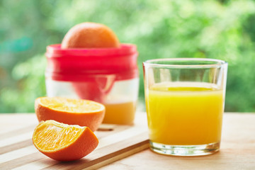 Glass, oranges and juicer