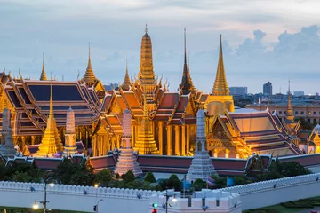Foto op Canvas The beauty of the Emerald Buddha Temple at twilight. And while the gold of the temple catching the light. This is an important buddhist temple of thailand and a famous tourist destination. © Southtownboy Studio