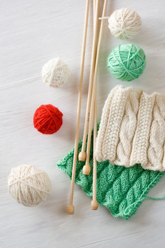 Two bright patterns, yarn balls and needles for knitting wooden