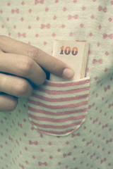 Taking money from  pocket with filter effect retro vintage style