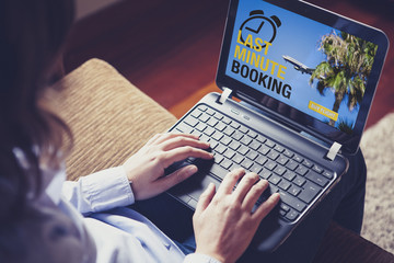 "Last Minute Booking" on the screen. Woman booking a flight.