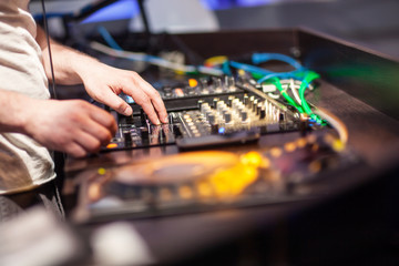 DJ mixing music on console