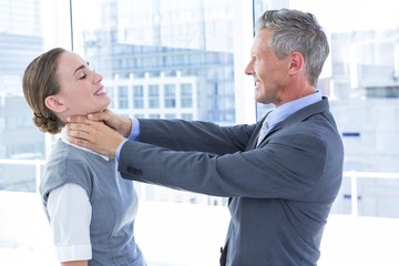 Businessman trying to smother his colleague