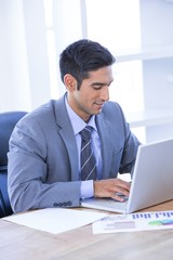 Fototapeta premium Businessman typing on his laptop