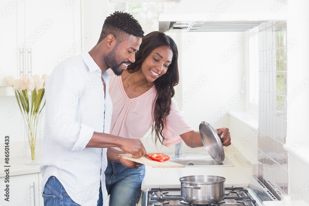 Wall mural happy couple cooking food together