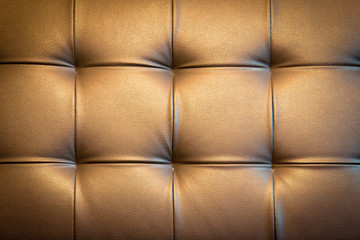 Genuine leather upholstery background for a luxury decoration in golden tone