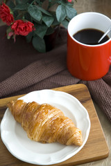croissant served on dish with coffee