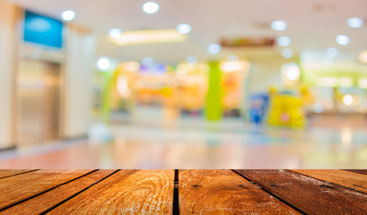 blurred image of shopping mall and people .