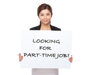 Confident businesswoman holding a placard showing with looking f