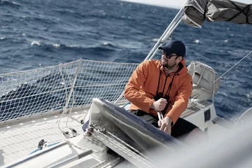 Papier Peint photo Naviguer Hipster man sailing with sails out on a sunny day