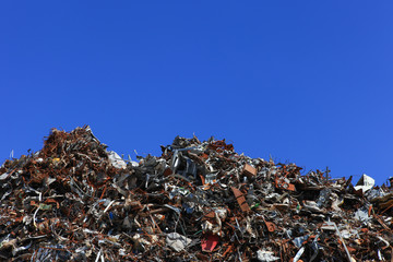 Scrap metal yard with clear blue sky
