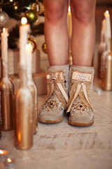 Woman's Legs In Glamour Felt Boots Standing Near New Year Tree
