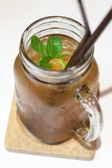 Ice tea in jar mug with lemon.