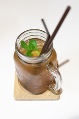 Ice tea in jar mug with lemon.