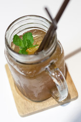 Ice tea in jar mug with lemon.