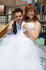 Beautiful newlywed couple outside looking at the camera