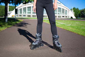 Inline skates - close up of female legs in skates