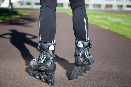 close up view of female legs in roller blades