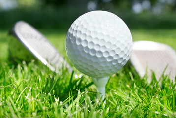 Golf club and ball in grass