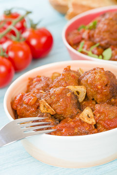 Albondigas Guisadas - Meatballs in tomato sauce with garlic slivers and thyme leaves.
