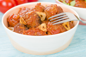Albondigas Guisadas - Meatballs in tomato sauce with garlic slivers and thyme leaves.
