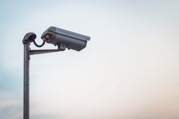 Security camera on blue sky background