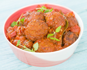 Albondigas Guisadas - Meatballs in tomato sauce with thyme leaves.
