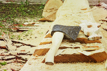 Splitting axe on a tree trunk taken closeup.