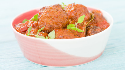 Albondigas Guisadas - Meatballs in tomato sauce with thyme leaves.
