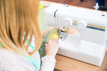 Female tailor using a sewing machine