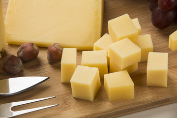 Different cheeses on a cutting board, delicious food