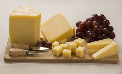 Different cheeses on a cutting board, delicious food