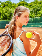 Girl sportsman with racket and ball on  tennis court