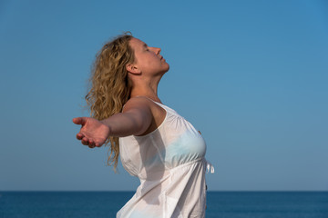 Woman relaxing with closed eyes, hands spread