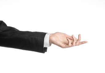 Businessman and gesture topic: a man in a black suit and white shirt showing hand gesture on an...