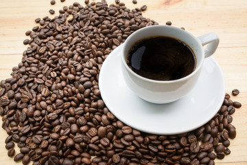 arabica coffee beans and cup full of coffee